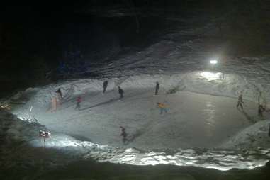 Friends skiing in frozen Minnesota pond