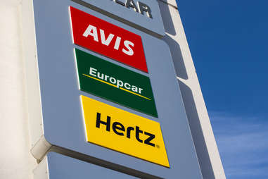 Signs for Avis, Europcar, and Hertz