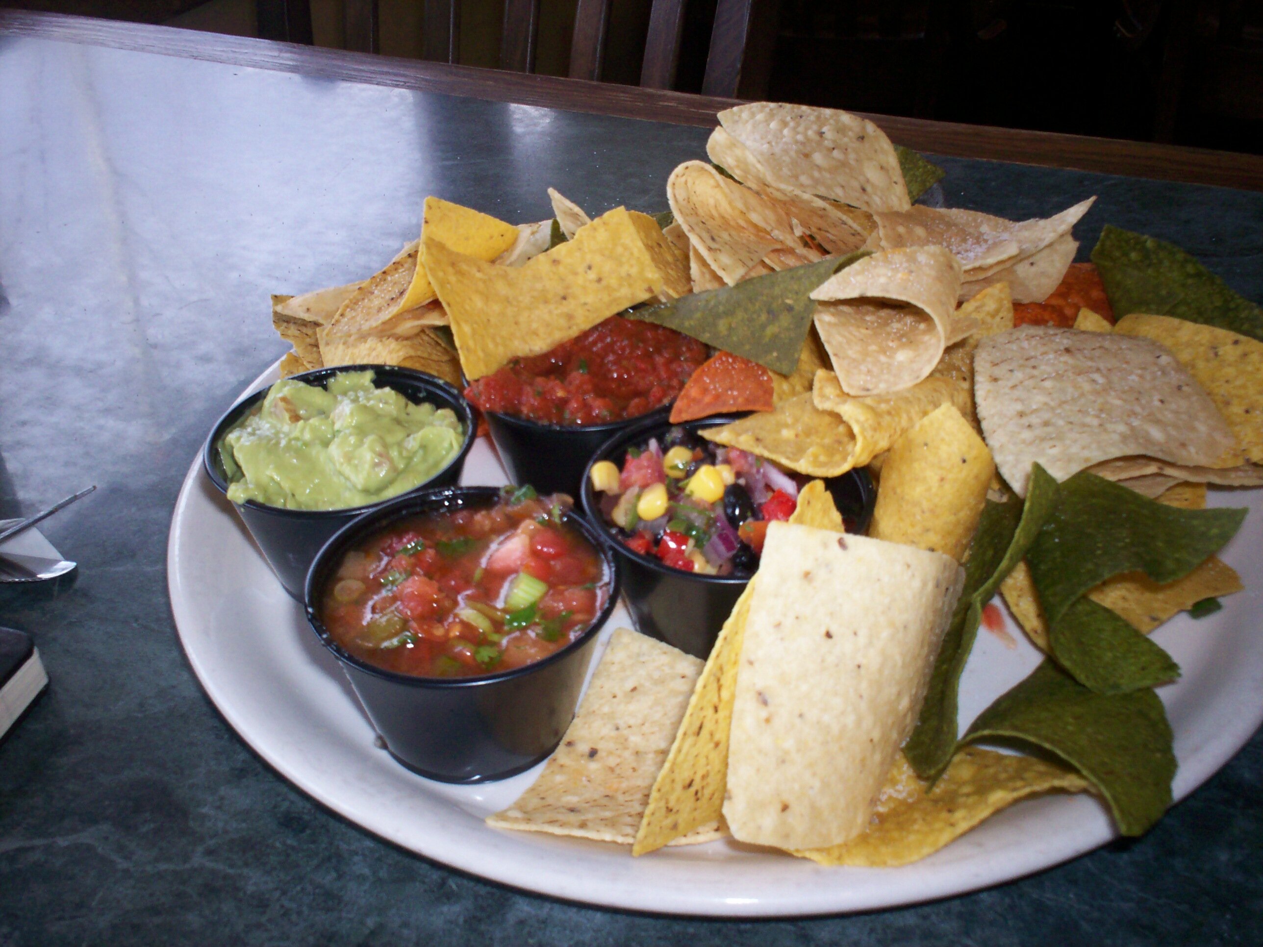 Chips with salsa on white plate