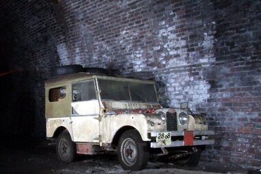 Land rover car in bad condition against brick wal