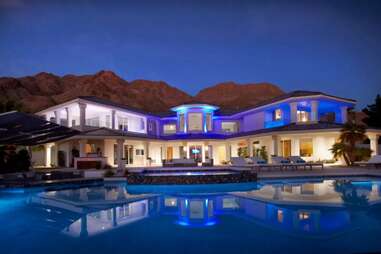 airbnb las vegas pool mansion night lit up