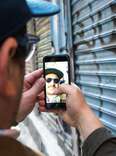 Man snapchatting by graffiti 