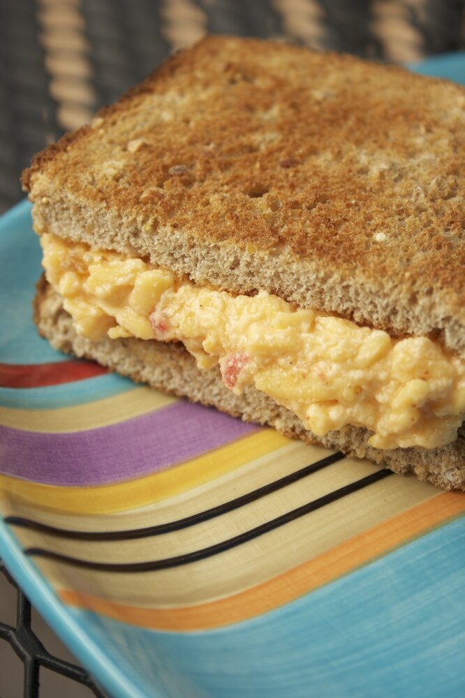 Pimento cheese sandwich on striped plate