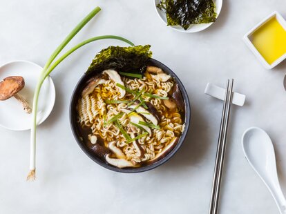 Bowl of ramen garnished with herbs