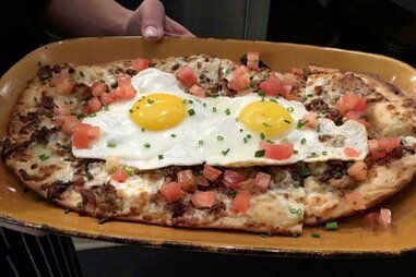 eggs on a flatbread with tomatoes