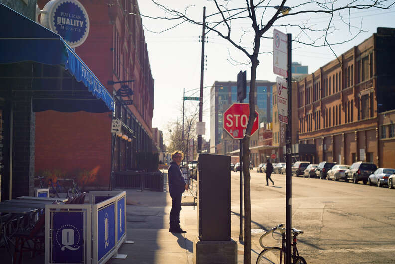 Man standing by stop sign in Chicago's west loop