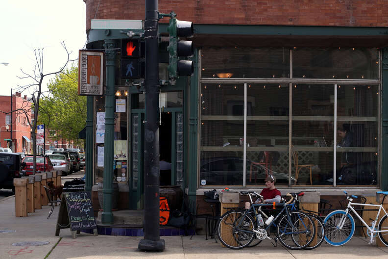 Man sitting in front of the store, next to bikes