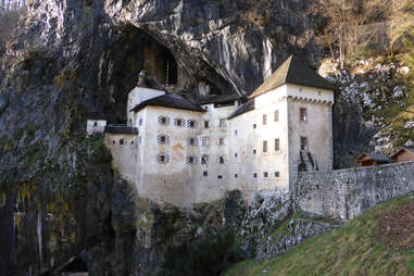 Predjama castle built into grassy corner Slovenia's landscape