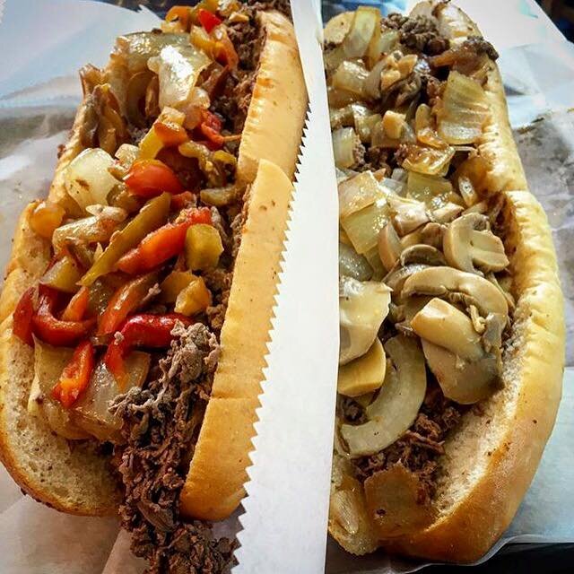 Two cheesesteaks wrapped in wax paper