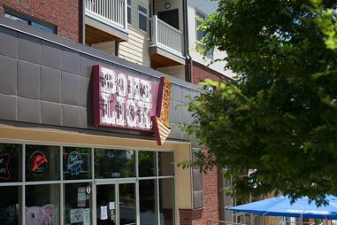 Front neon sign of Bone Lick BBQ store