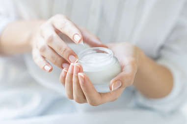 woman with jar of moisturizer