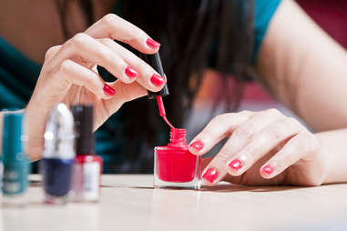 woman painting her nails with nail polish