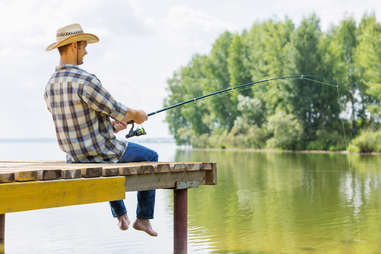 man in cowboy hat and plaid fishing