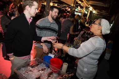 Visitors of Sip Savor Stomp receiving glasses of wine