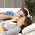 man and woman sick together on couch