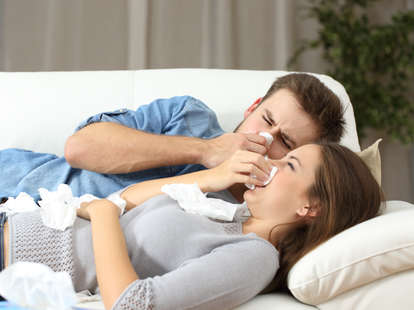 man and woman sick together on couch