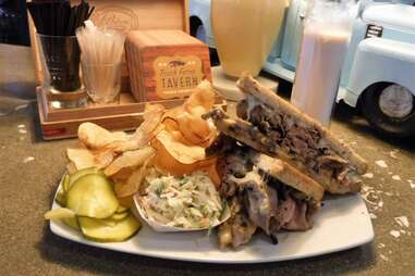 Plate with brisket sandwich and potato chips