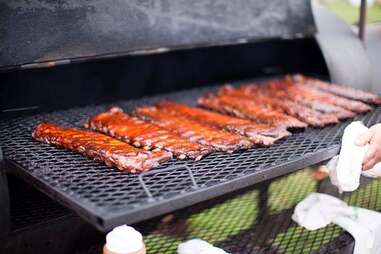 Ribs being cooked on a grill at McClure’s