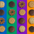 Assorted girl scout cookies on colorful background