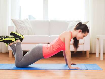 woman doing a push up in apartment living room exercise routine