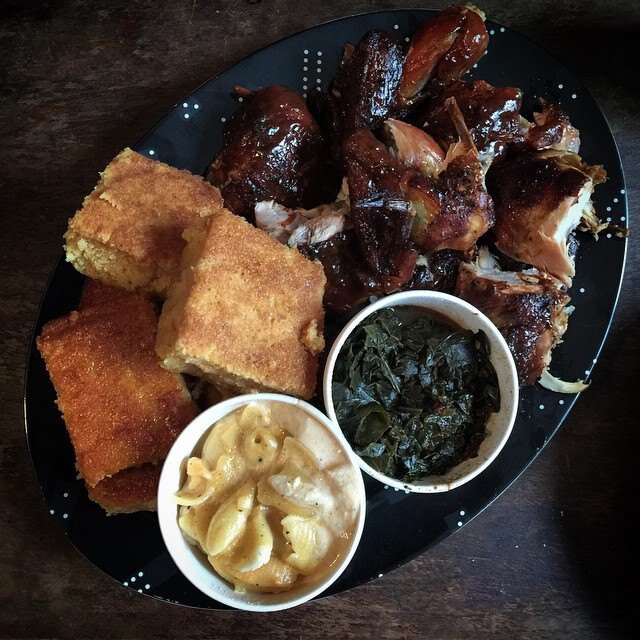 Platter of corn bread, collar greens, and BBQ bits