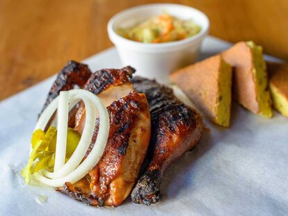 Barbecue chicken with corn bread on wax paper