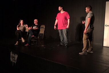 Comedians performing on stage of Village Theater