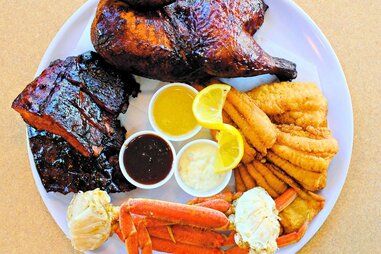 Plate with BBQ, crab legs, and fried chicken