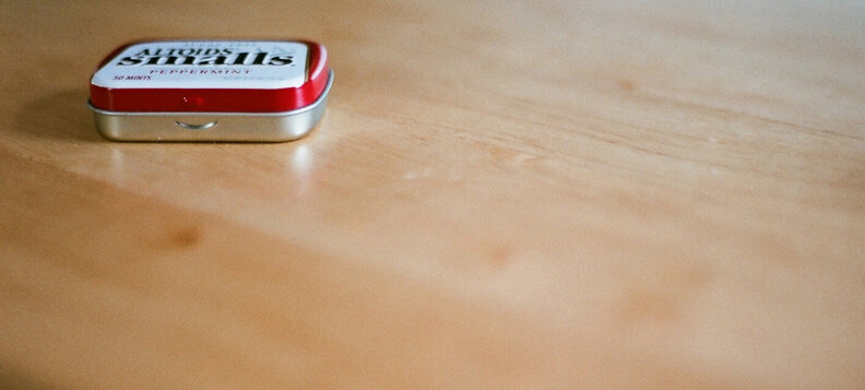 Container of small Altoids on table