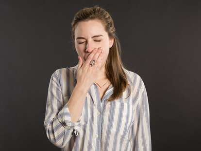 sleepy woman yawning thrillist