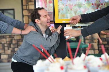 Lee Breslouer being forcefed a milkshake