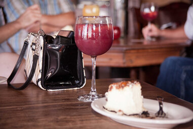 Cocktail and slice of cake