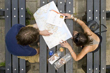 man and woman looking at a map planning a trip