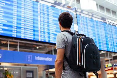 traveler with backpack in an airport
