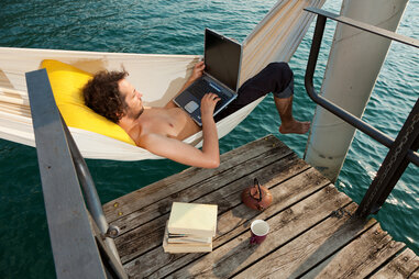 man on a hammock working