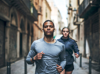 Runners exercising with ear buds Spotify