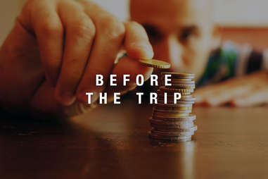 man counting coins and saving money for trip