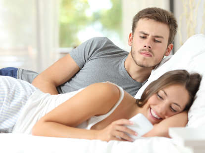 jealousy couple woman texting in bed