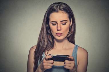 anxious confused worried woman texting jealousy issues in relationships