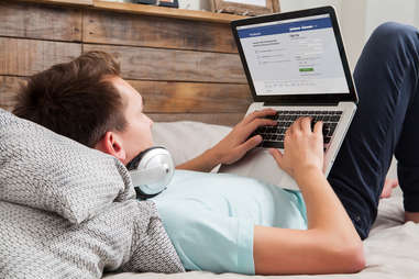 man laying down on his laptop