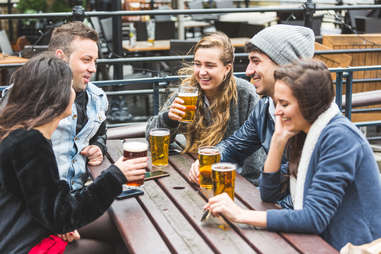 group of friends drinking beer outside hygge