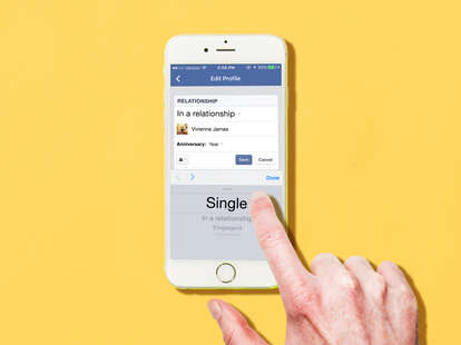 Finger changing relationship status to single on Facebook mobile on iPhone
