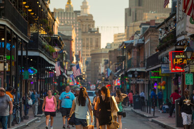 people walking down bourbon street in new orleans