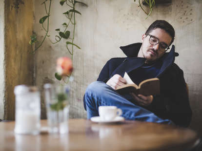 Man reading book by himself