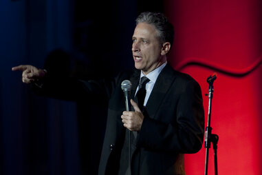 Jon Stewart with mic on stage