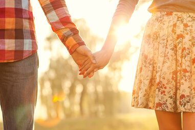 couple holding hands in the sunshine happiness