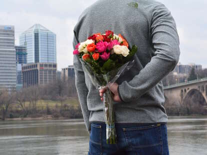 man apologizing with flowers, man holding flowers