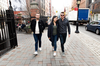 A couple walks down the road as a jealous friend follows