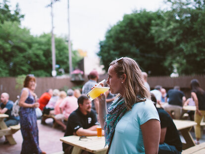 woman drinking at outdoor beer garden cleveland