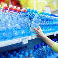 woman buying plastic water bottles